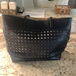 Leather navy cutout shoulder bag with cream colored insert - clip in navy pouch.